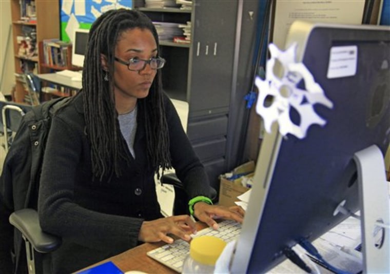 Nkomo Morris, a teacher at Brooklyn's Art and Media High School, works on her classroom computer in New York. Morris, who teaches English and journalism, said she has about 50 current and former students as Facebook friends. That could be a problem if the new rules instruct teachers not to friend students. 